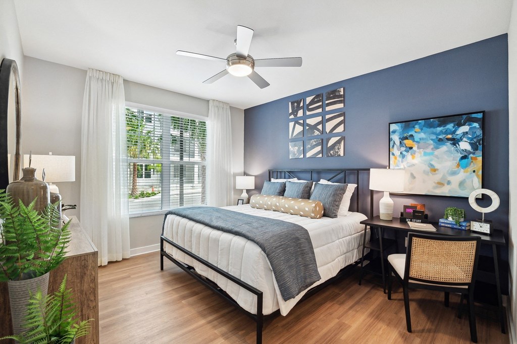 a bedroom with a bed and a ceiling fan