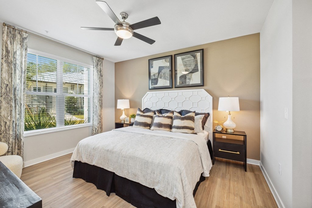 a bedroom with a bed and a ceiling fan