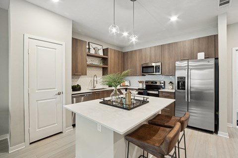 a kitchen with stainless steel appliances and a white counter top