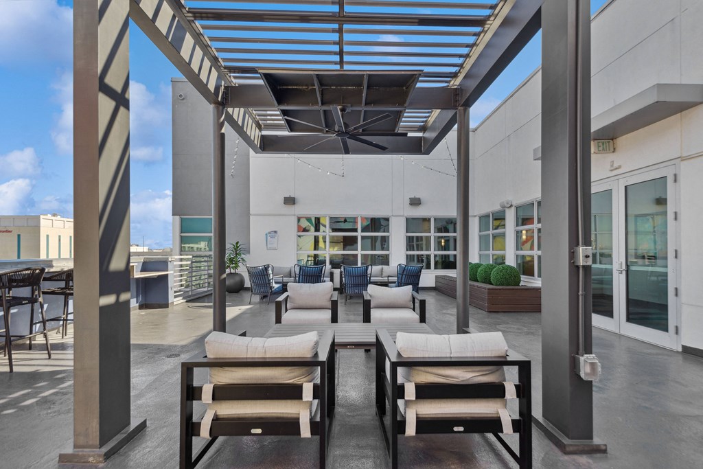 a lounge area with couches and chairs and tables