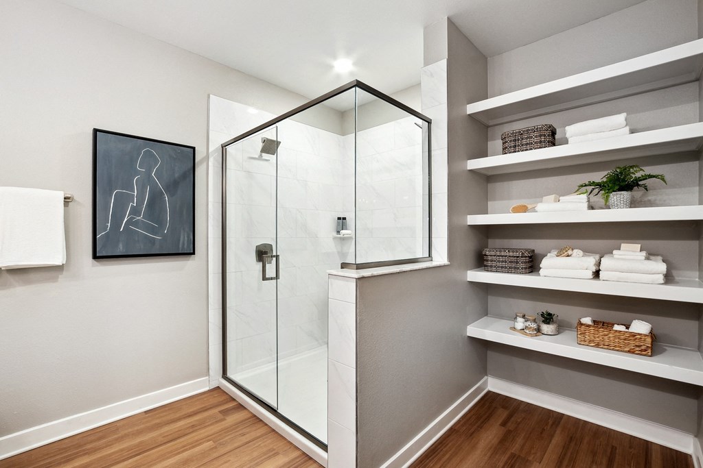a walk in shower with a glass door in a bathroom