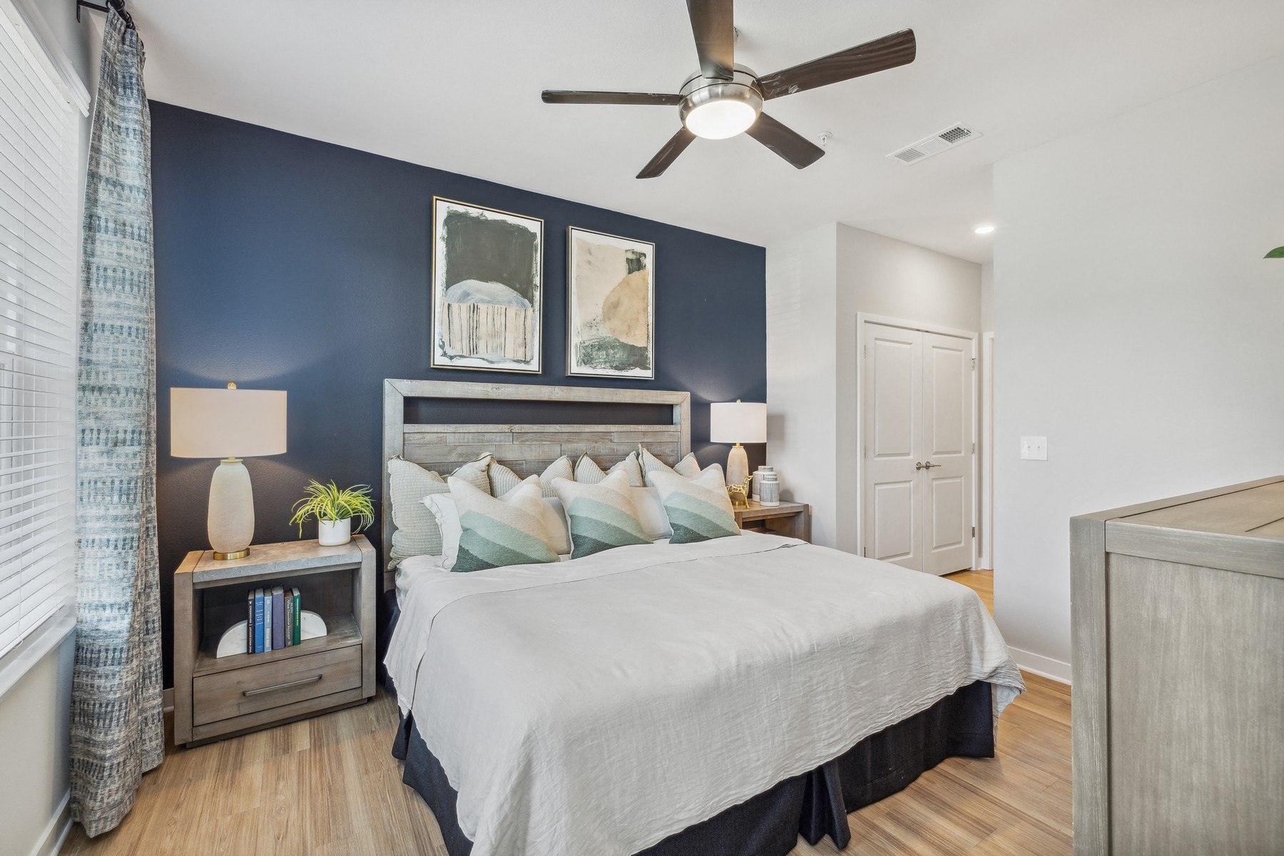 a bedroom with a bed and a ceiling fan