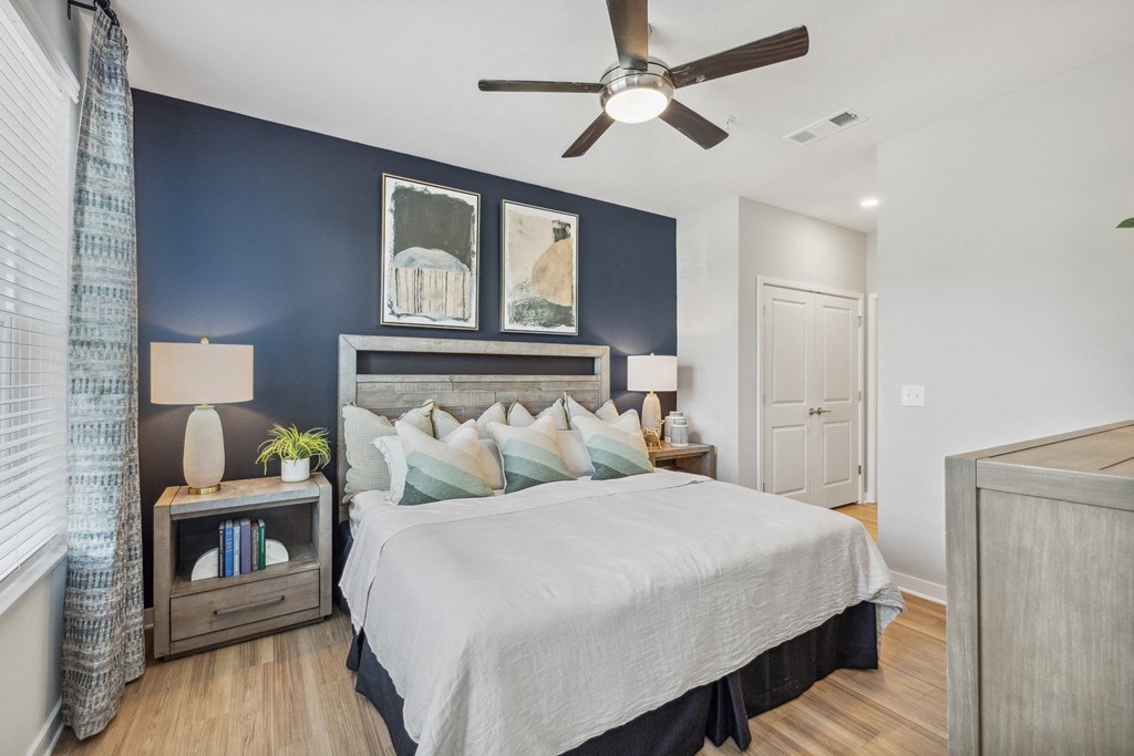 a bedroom with a bed and a ceiling fan