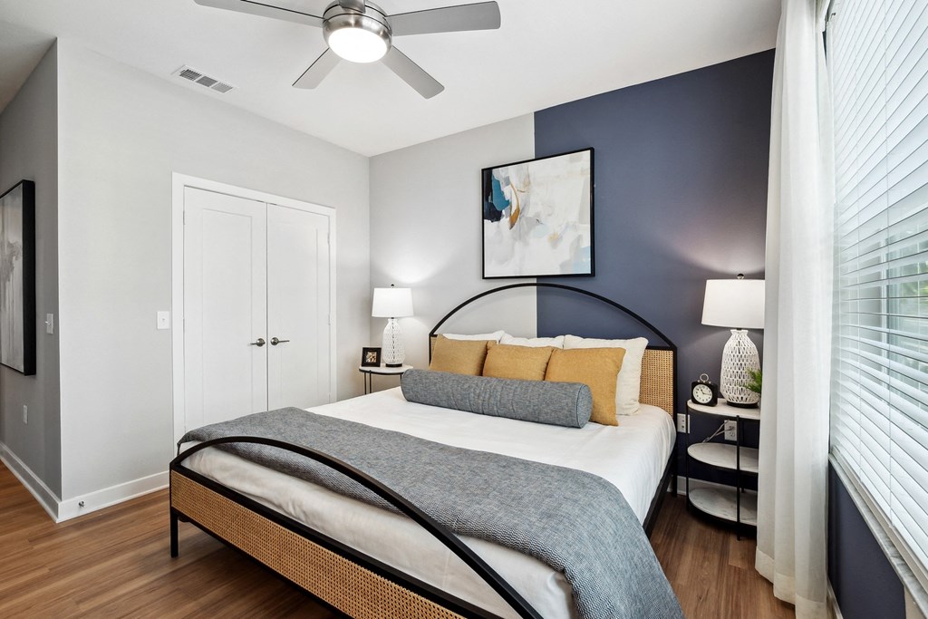 a bedroom with a bed and a ceiling fan