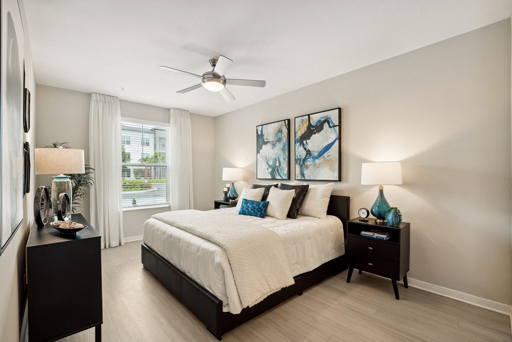 a bedroom with a large bed and a ceiling fan