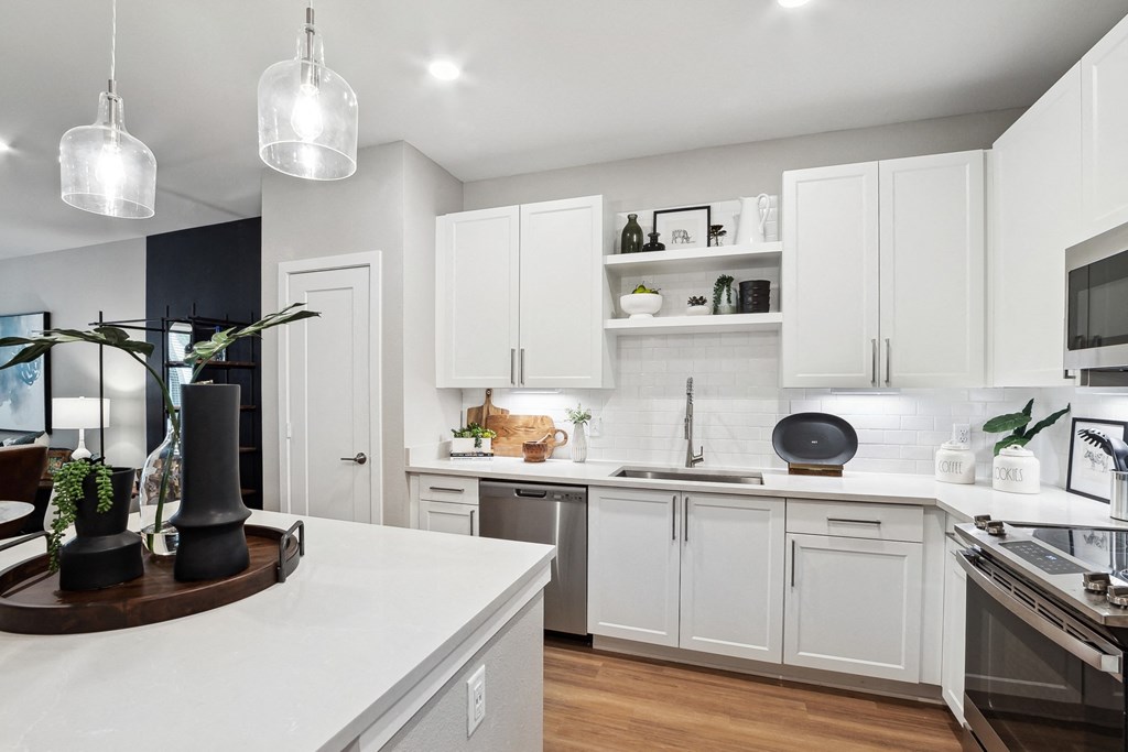 a kitchen with white cabinets and a white counter top