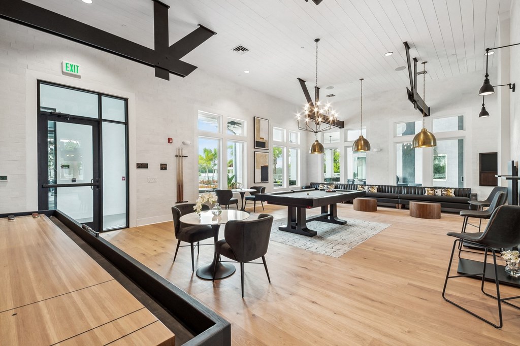 a large living room with tables and chairs and a ping pong table