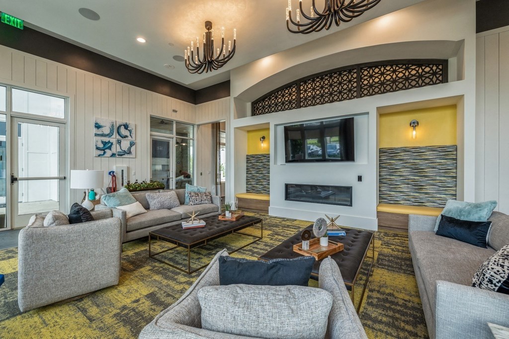a living room with couches and chairs and a fireplace