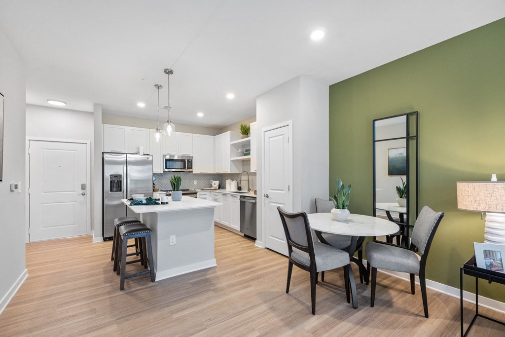 an open kitchen and dining room area with a table and chairs
