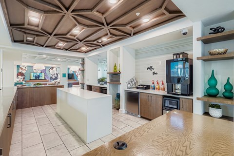 A kitchen with a white counter and wooden shelves.