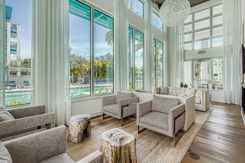 A living room with grey couches and a wooden floor.