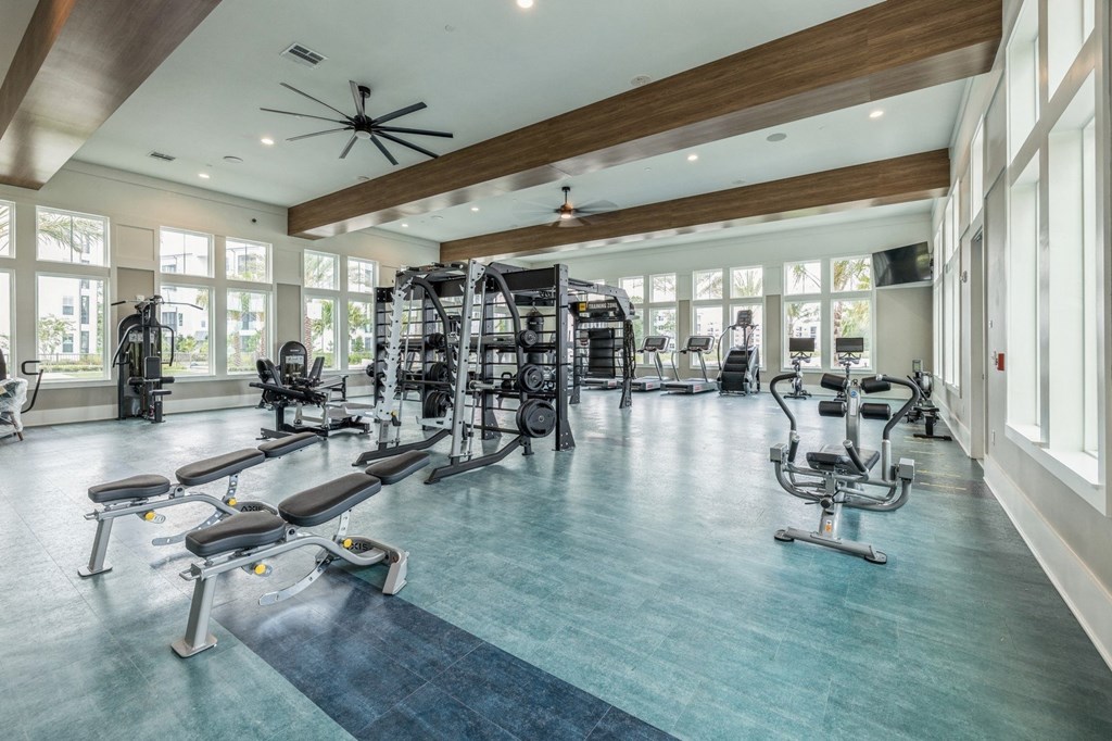 the generously sized fitness room has cardio equipment and large windows