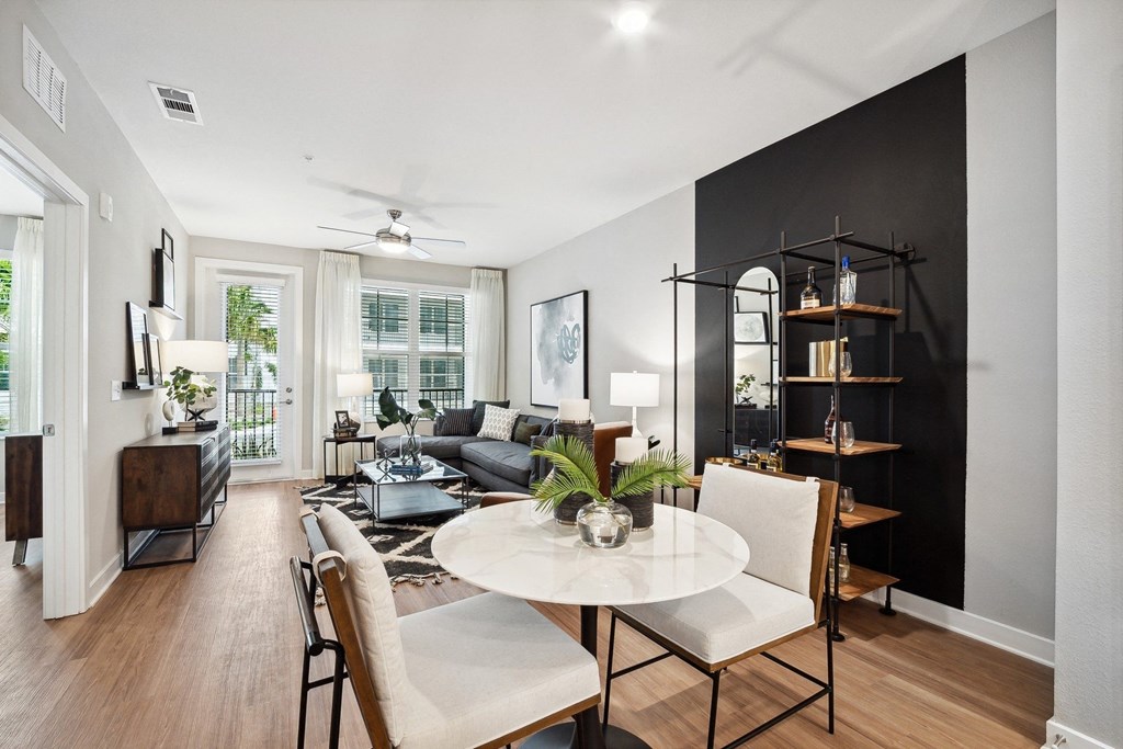 a living room with a dining room table and a couch