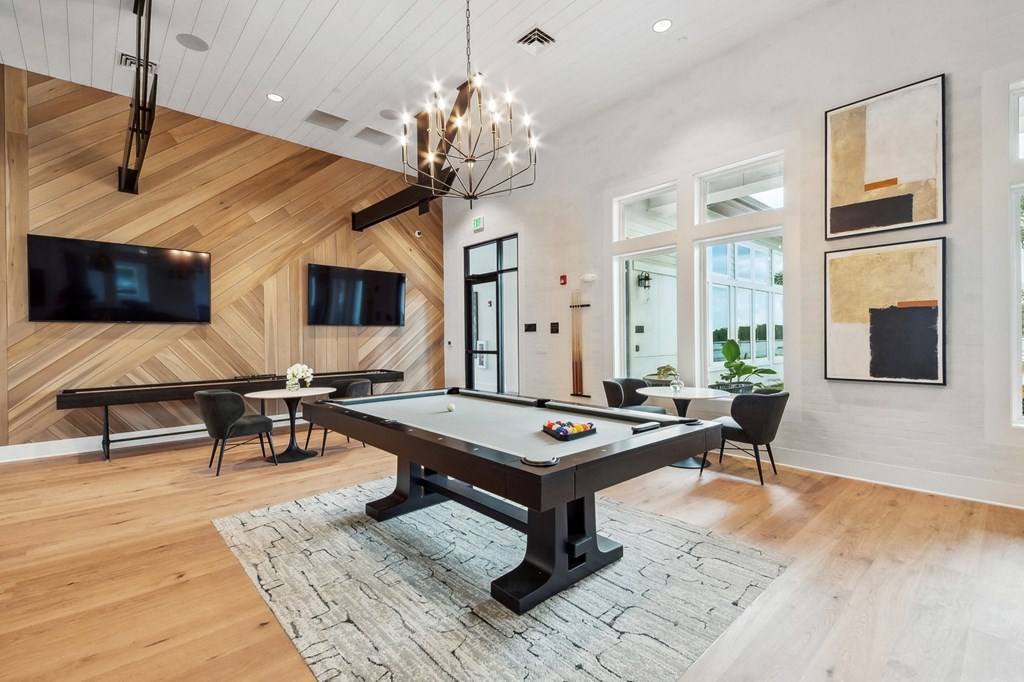 a game room with a pool table and a tv
