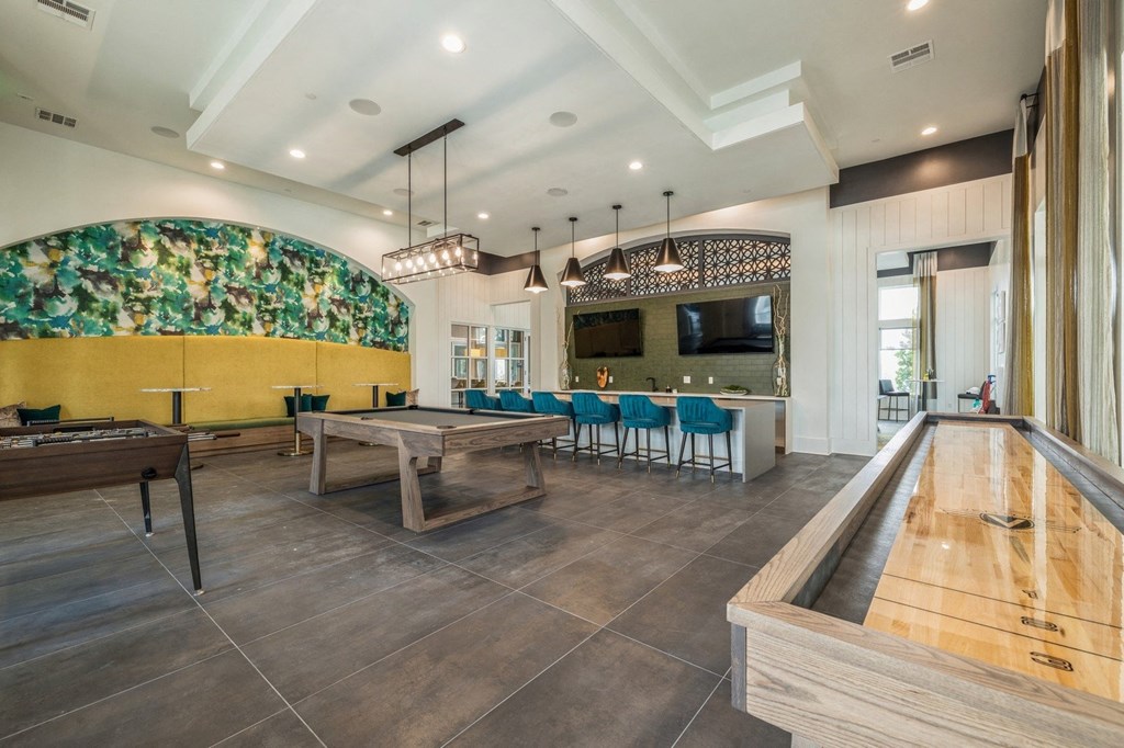 a game room with a pool table and a television