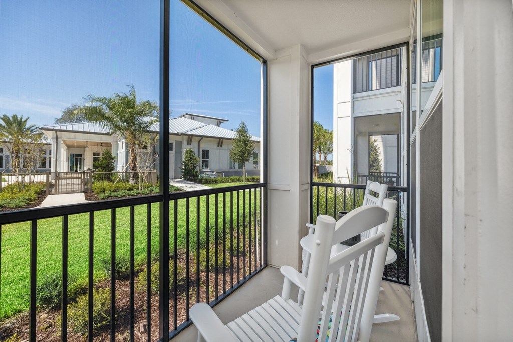 the preserve at ballantyne commons balcony with white rocking chairs and grass and trees