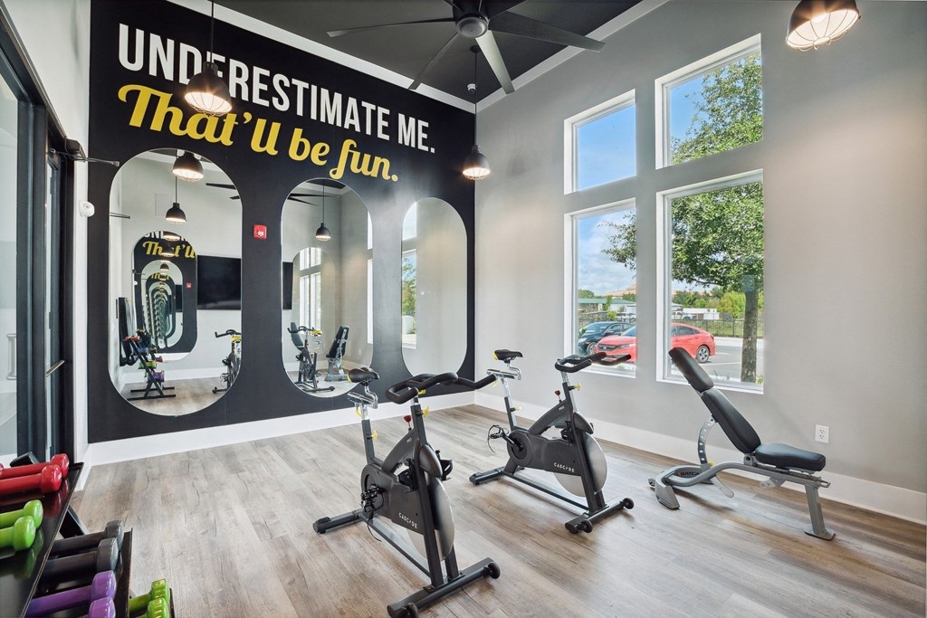 a gym with exercise bikes and a sign on the wall that says unlimited resistance me