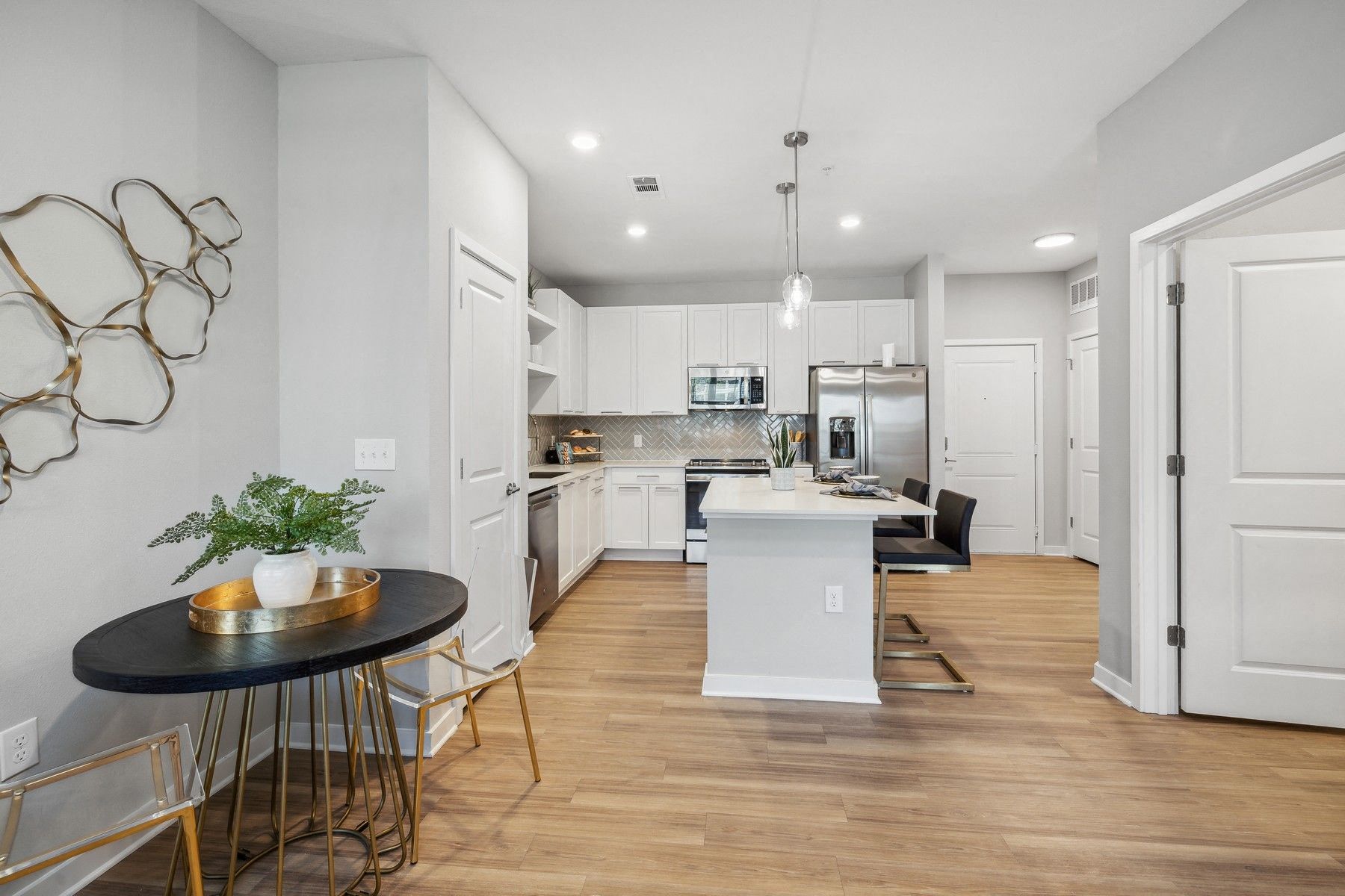 an open kitchen and living room with a table and chairs