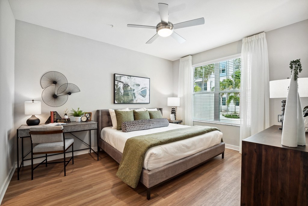 a bedroom with a bed and a ceiling fan