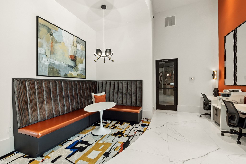 a room with a table and a chair and a painting on the wall