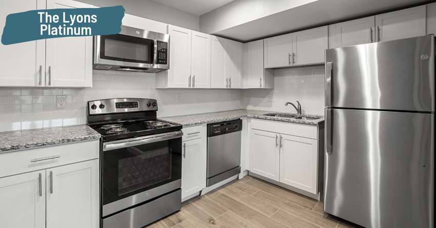 a kitchen with stainless steel appliances and white cabinets
