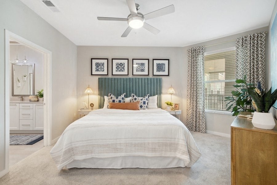 a bedroom with a bed and a ceiling fan