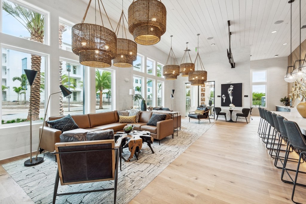 a large living room with couches and chairs and large windows