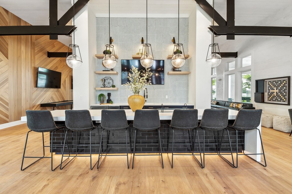 a large dining room with a long table and chairs and lamps