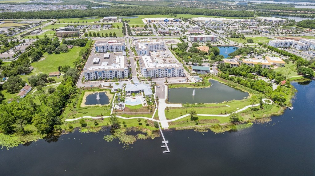 an aerial view of a city with a body of water