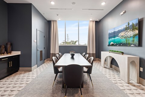 A modern dining room with a large table and chairs.