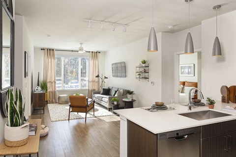 A modern kitchen with a dining area and a living room.