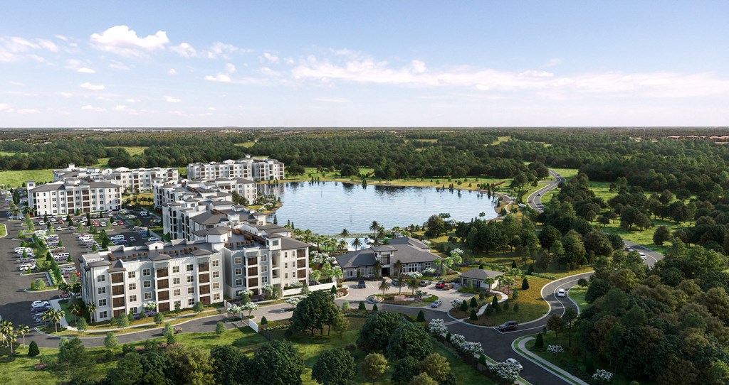 an aerial view of an apartment complex with a lake