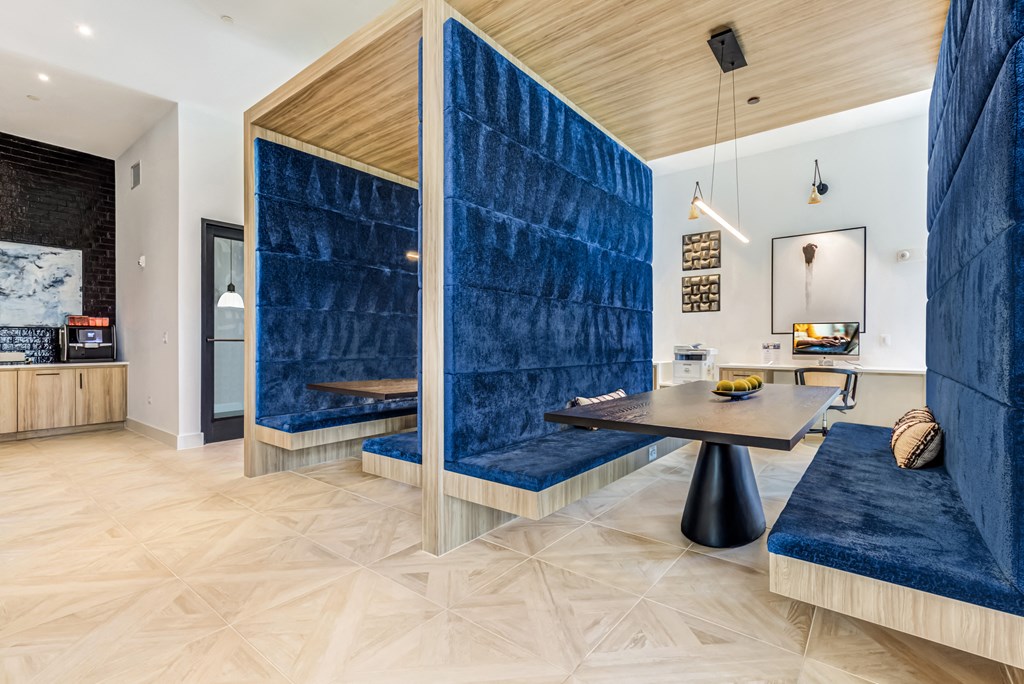 a living room with a blue wall and a table and a couch