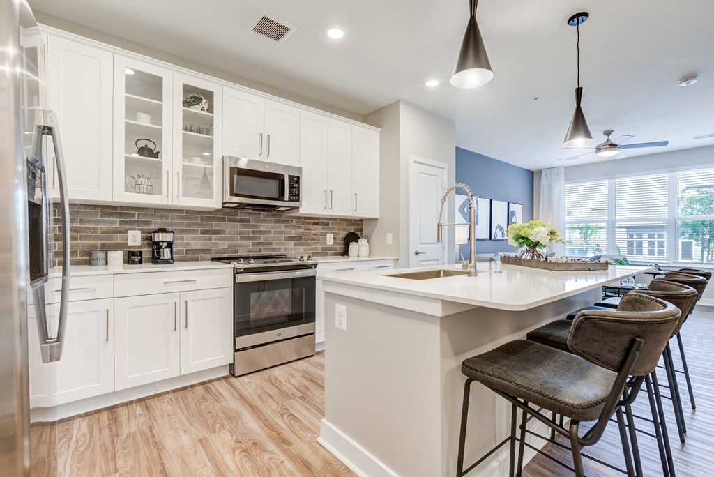 a kitchen with white cabinets and a white counter top