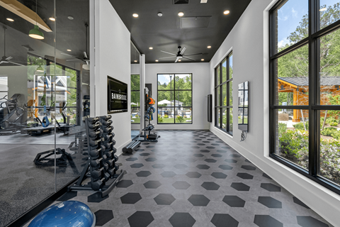 A gym with a variety of equipment including a blue exercise ball.