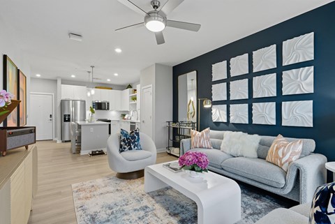 A modern living room with a grey sofa and a white coffee table.