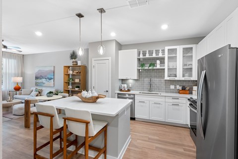 A modern kitchen with a dining table and chairs.