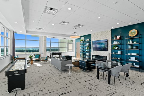 a living room with a table and chairs and a television