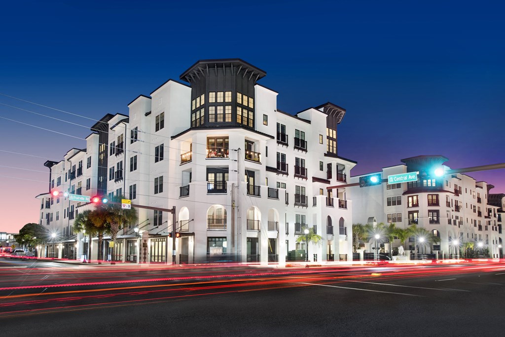 a rendering of an apartment building at night with traffic lights