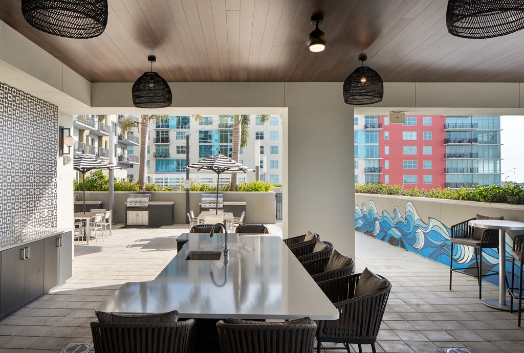 a patio with tables and chairs and a building in the background