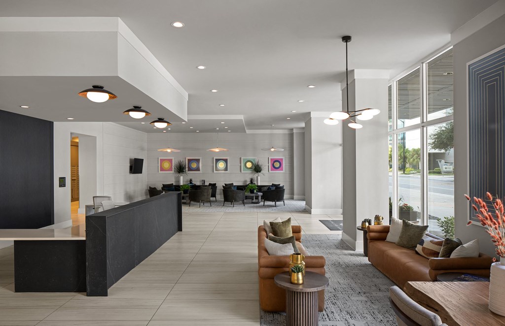 a lobby with couches and chairs and a reception desk