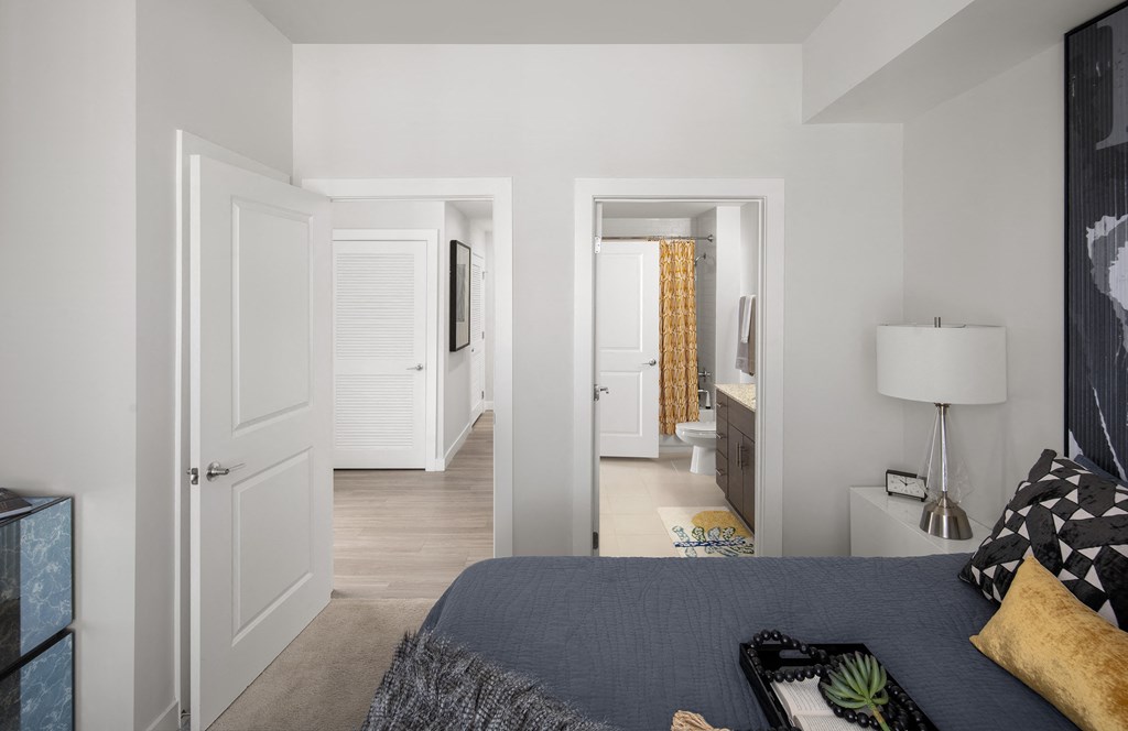 a bedroom with a bed and a door to a bathroom