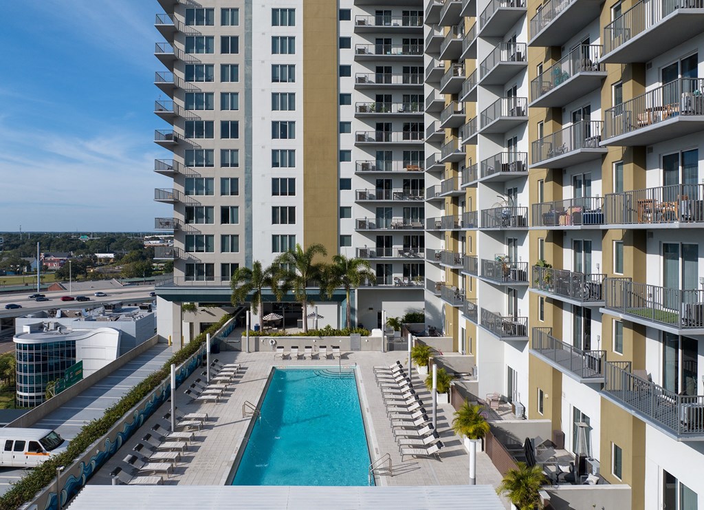 a swimming pool in front of an apartment building