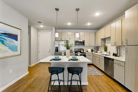 A modern kitchen with a dining table and chairs.