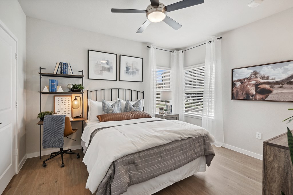 a bedroom with a bed and a ceiling fan