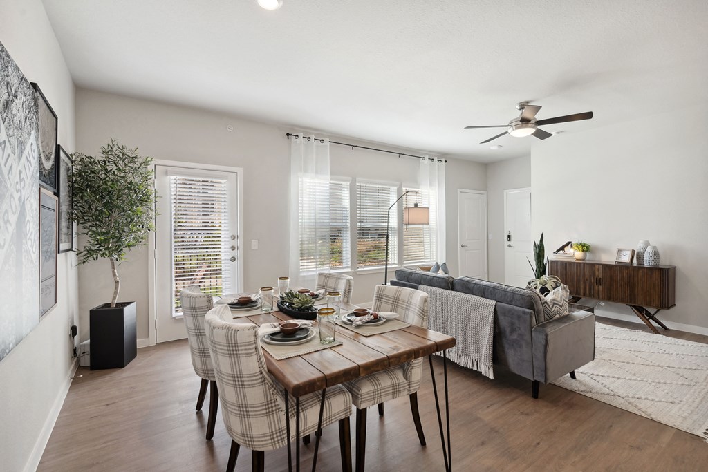 a living room with a dining room table and a couch