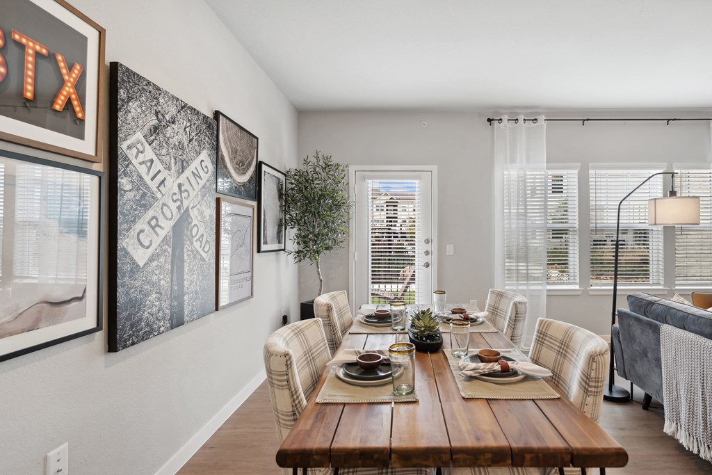 a dining room with a wooden table and chairs