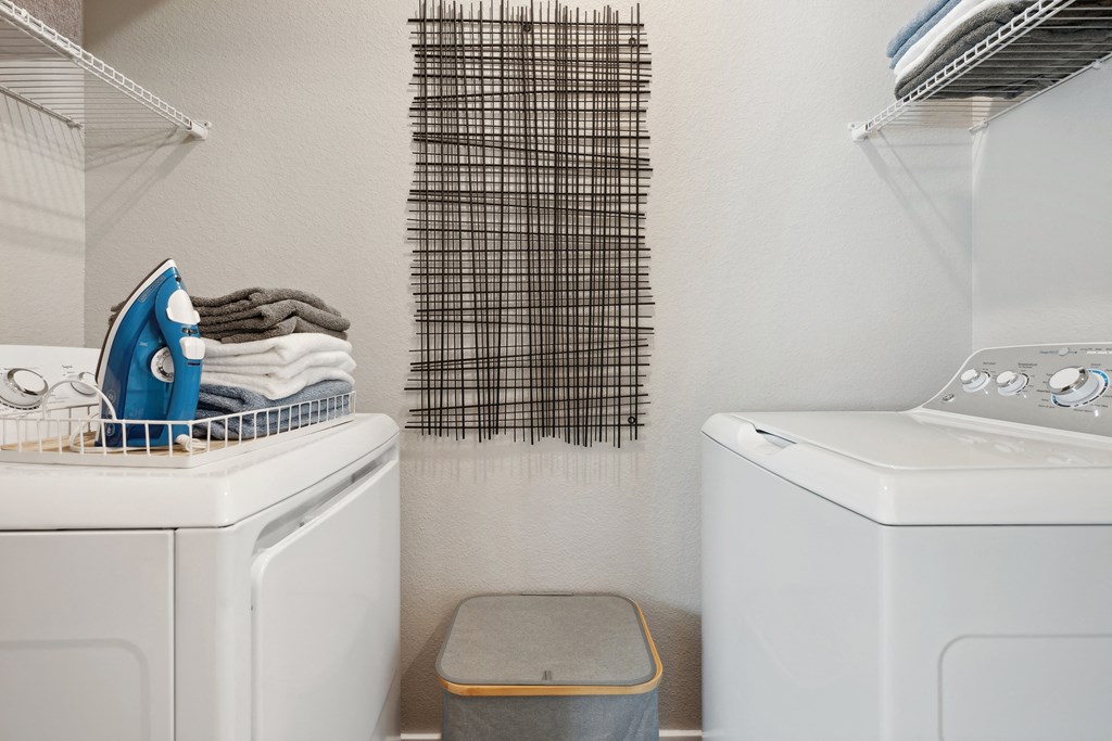 a small laundry room with two washes and a dryer