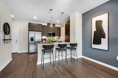 A modern kitchen with a dining table and chairs.