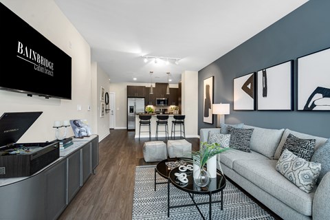 A modern living room with a grey sofa and a coffee table.
